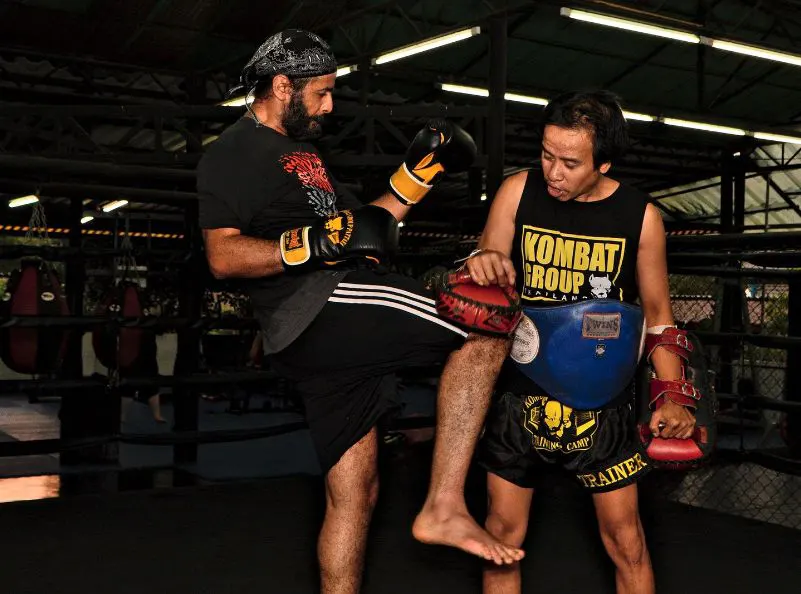 Knees on the mitts during a beginner muay thai class at Kombat Group