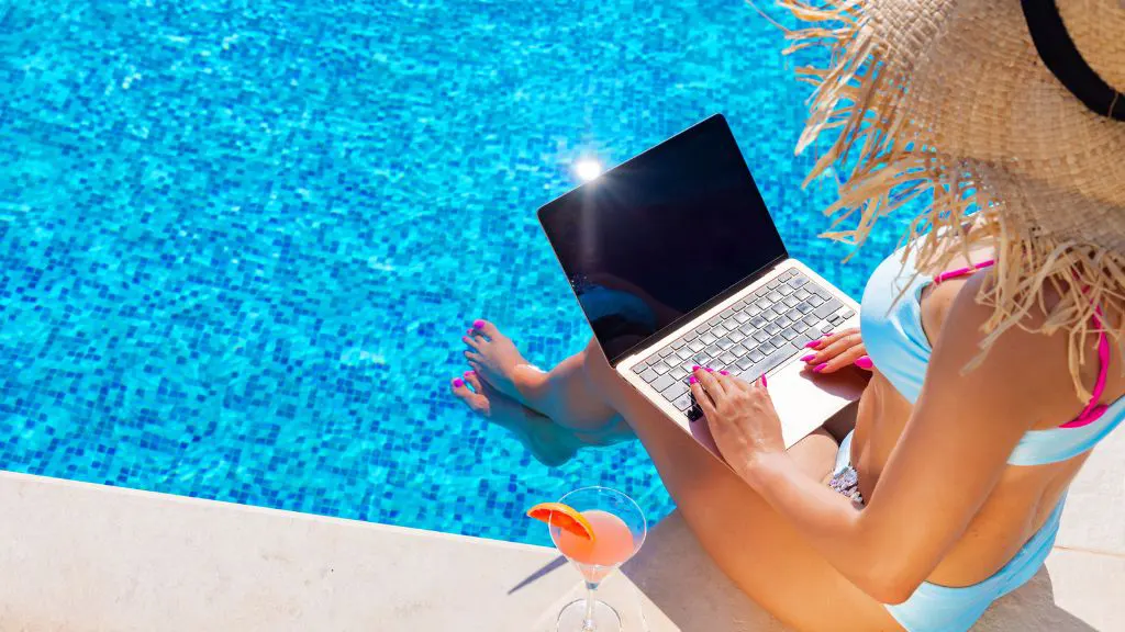 Digital nomad working from a swimming pool