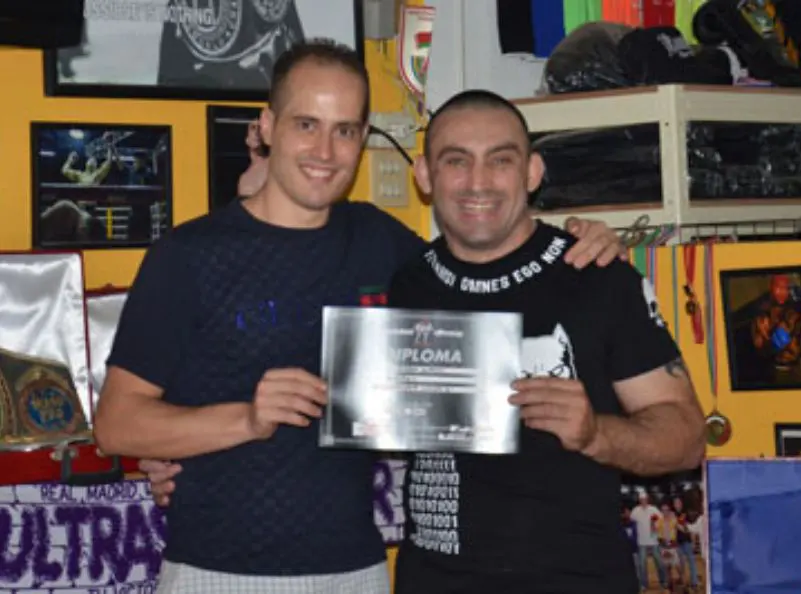 Marco Corapi getting his diploma from Christian Daghio