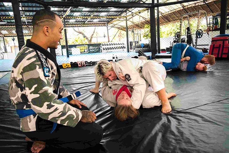 Two Women Rolling on the Kombat Group Mat