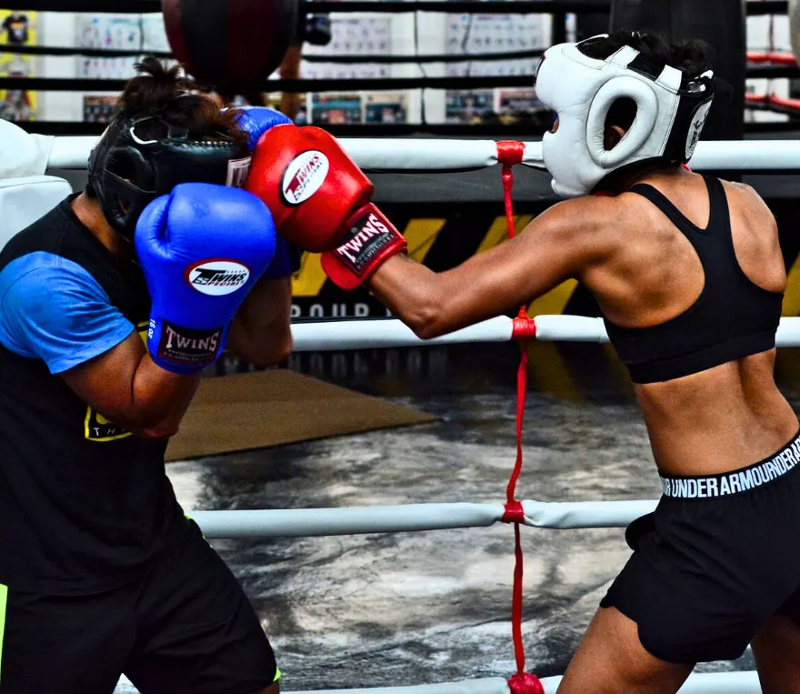 Woman sparring with Kombat Group trainer